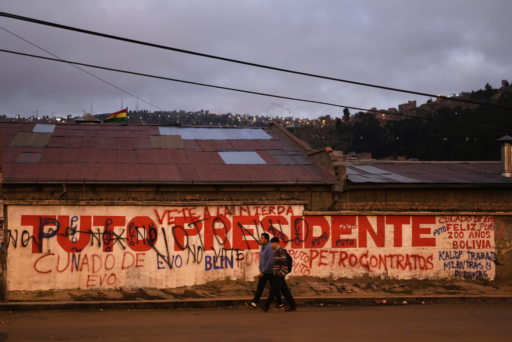 A man walks past a campaign sign for presidential candidate Jorge "Tuto" Quiroga prior to Sunday's presidential and legislative elections in El Alto, Bolivia, Thursday, Aug. 14, 2025. (AP Photo/Juan Karita)