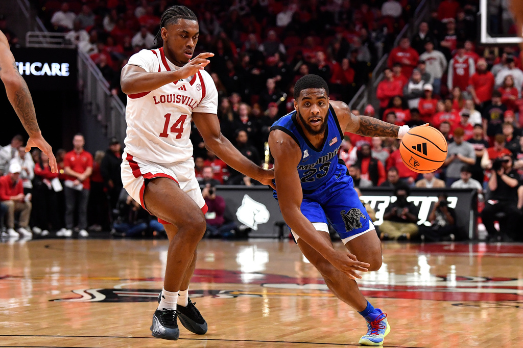 Memphis guard Sincere Parker (23) drives past Louisville guard Adrian Wooley (14) during the first half of an NCAA college basketball game in Louisville, Ky., Saturday, Dec. 13, 2025. (AP Photo/Timothy D. Easley)