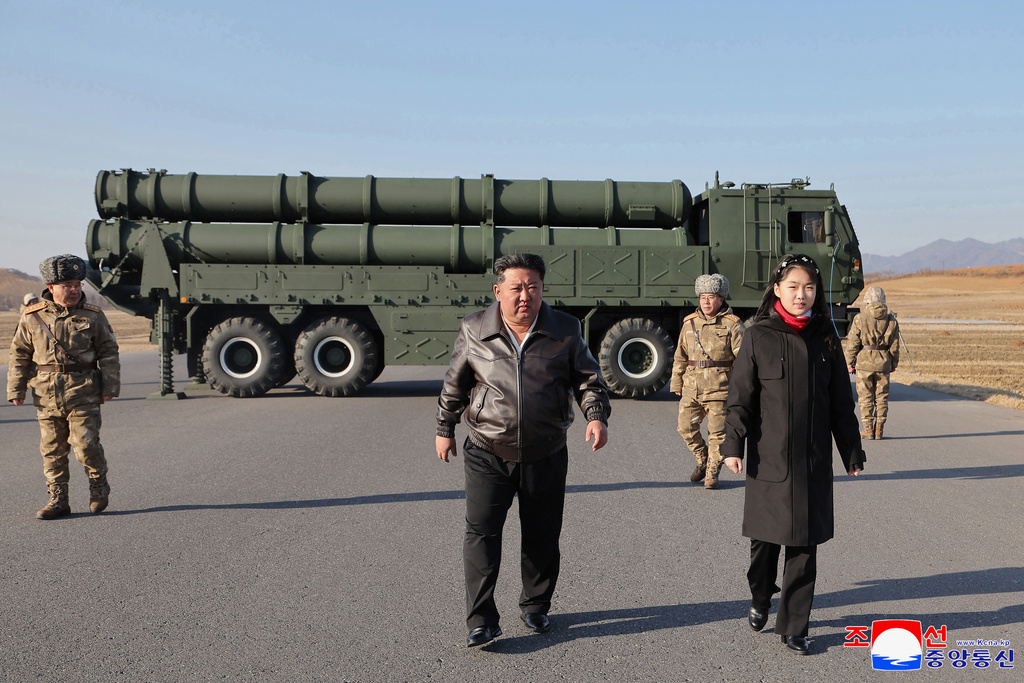 In this photo provided by the North Korean government, its leader Kim Jong Un, with his daughter, believed to be named Kim Ju Ae, inspects test-firing of ballistic missiles from an undisclosed location in North Korea, Tuesday, Jan. 27, 2026. Independent journalists were not given access to cover the event depicted in this image distributed by the North Korean government. The content of this image is as provided and cannot be independently verified. Korean language watermark on image as provided by source reads: "KCNA" which is the abbreviation for Korean Central News Agency. (Korean Central News Agency/Korea News Service via AP)