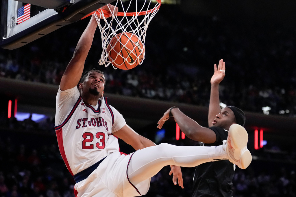 St. John's forward Bryce Hopkins (23) dunks during the first half of an NCAA college basketball game against the Providence in the quarterfinals of the Big East tournament, Thursday, March 12, 2026, in New York. (AP Photo/Yuki Iwamura)