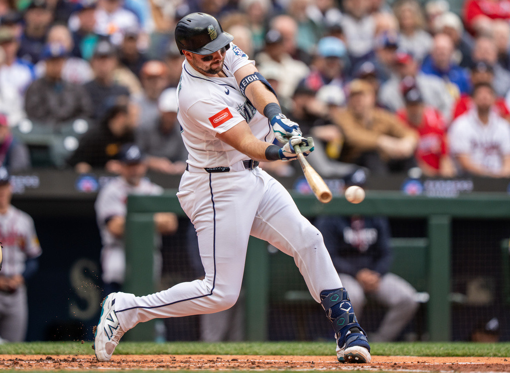 Seattle Mariners' Cal Raleigh hits into a double play to bat in a run during the third inning of a baseball game against the Atlanta Braves, Wednesday, May 6, 2026, in Seattle. (AP Photo/Stephen Brashear)