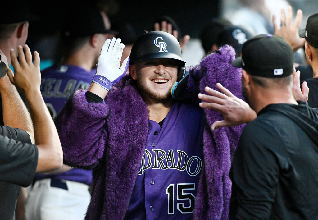 Colorado Rockies' Hunter Goodman celebrates in the dugout after hitting a two-run home run in the fifth inning of a baseball game against the Miami Marlins Wednesday, July 1, 2026, in Denver. (AP Photo/Geneva Heffernan)