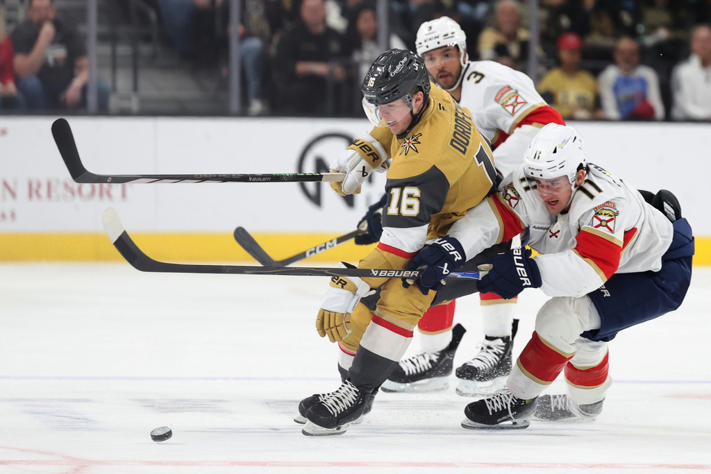 Vegas Golden Knights right wing Pavel Dorofeyev (16) skates against Florida Panthers defenseman Seth Jones (3) and right wing Mackie Samoskevich (11) during the first period of an NHL hockey game Monday, Nov. 10, 2025, in Las Vegas. (AP Photo/Ian Maule)