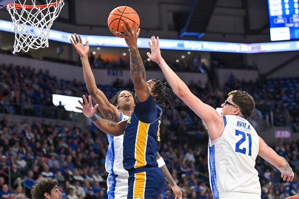 La Salle Frward Josiah Harris (5) shoots shoots past Saint Louis center Robbie Avila (21) during the first half of an NCAA college basketball game Saturday, Feb. 7, 2026, in St. Louis. (AP Photo/Ali Overstreet)