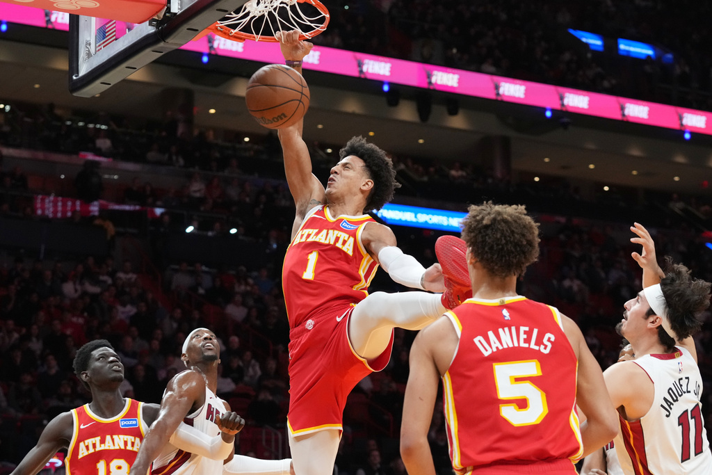 Atlanta Hawks forward Jalen Johnson (1) dunks the ball during the first half of an NBA basketball game against the Miami Heat Tuesday, Feb. 3, 2026, in Miami. (AP Photo/Marta Lavandier)