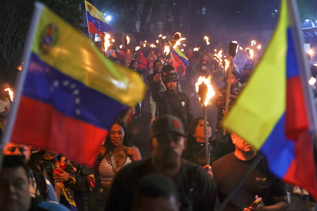 People march in support of former President Nicolas Maduro and first lady Cilia Flores in the 23 de Enero neighborhood in Caracas, Venezuela, Wednesday, March 25, 2026. (AP Photo/Pedro Mattey)