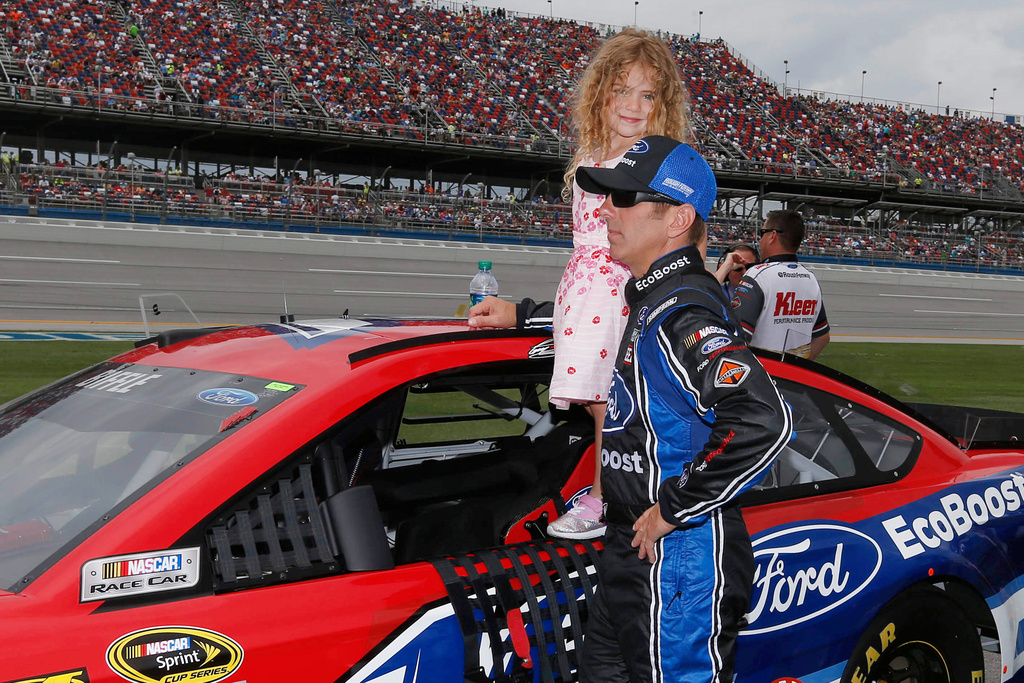 FILE - NASCAR driver Greg Biffle holds his daughter Emma Elizabeth during driver introductions fo the NASCAR Talladega auto race at Talladega Superspeedway, Sunday, May 1, 2016, in Talladega, Ala. (AP Photo/Brynn Anderson, File)