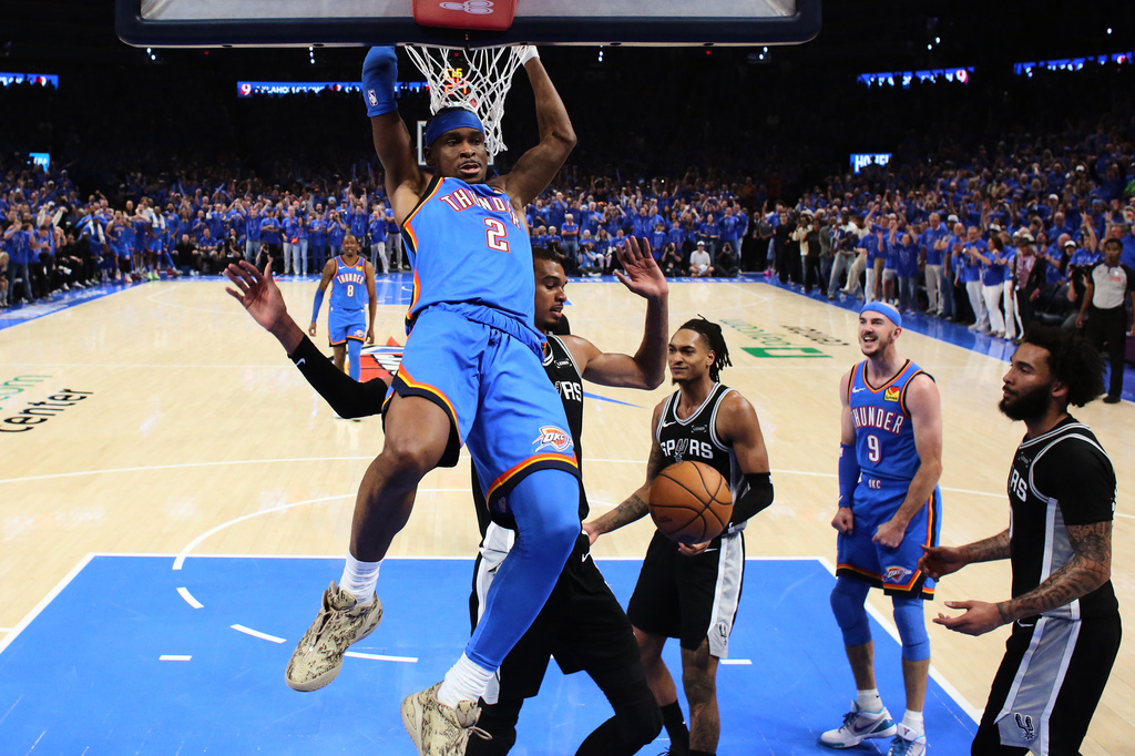 Oklahoma City Thunder guard Shai Gilgeous-Alexander (2) dunks against San Antonio Spurs forward Victor Wembanyama (1) during the first half of Game 1 in a third-round NBA basketball playoffs series Monday, May 18, 2026, in Oklahoma City. (AP Photo/Nate Billings)
