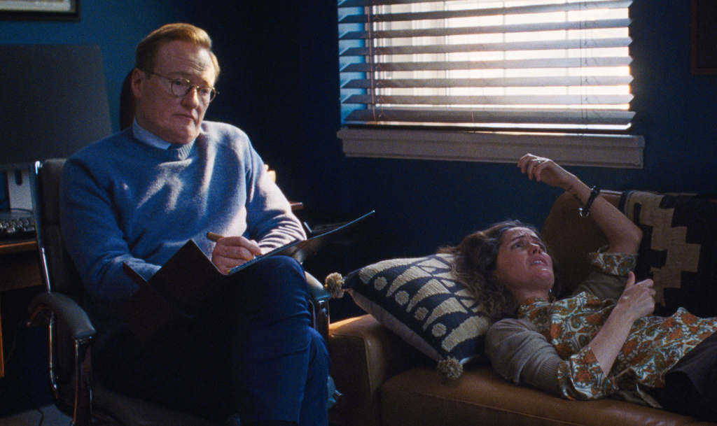 This image released by A24 shows Conan O'Brien, left, and Rose Byrne in a scene from " If I Had Legs I'd Kick You." (Logan White/A24 via AP)