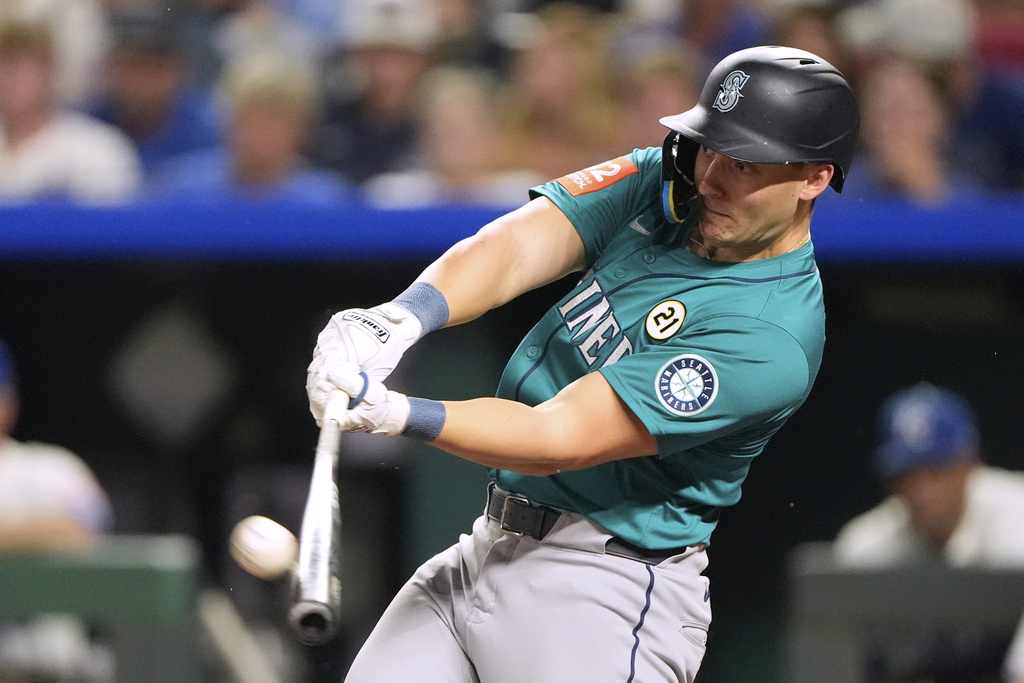 Seattle Mariners' Dominic Canzone hits a solo home run during the fifth inning of a baseball game against the Kansas City Royals, Tuesday, Sept. 16, 2025, in Kansas City, Mo. (AP Photo/Charlie Riedel)