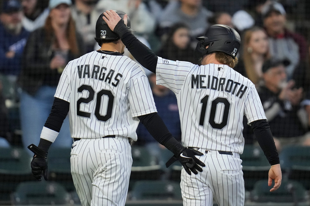 Chicago White Sox's Miguel Vargas (20), left, and Chase Meidroth (10) celebrate after scoring on a single from Randal Grichuk (34) during the third inning of a baseball game against the Kansas City Royals, Thursday, May 14, 2026, in Chicago. (AP Photo/Erin Hooley)