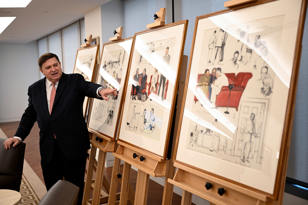 Stewart McLaurin, president of the White House Historical Association, displays a newly-acquired suite of four interrelated paintings by Norman Rockwell titled, "So You Want to See the President!" at the association's offices Wednesday, June 10, 2026, in Washington. (AP Photo/John McDonnell)