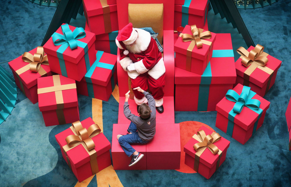 FILE - A young visitor describes to Santa Claus what he hopes to get for Christmas at Altamonte Mall on Dec. 21, 2022, in Altamonte Springs, Fla. (Joe Burbank/Orlando Sentinel via AP, File)