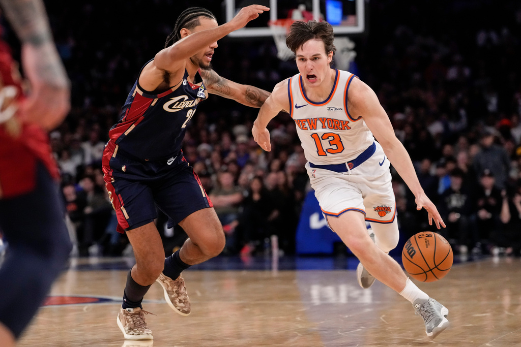 New York Knicks guard Tyler Kolek (13) drives past Cleveland Cavaliers guard Jaylon Tyson (20) during the second half of an NBA basketball game, Thursday, Dec. 25, 2025, in New York. (AP Photo/Yuki Iwamura)