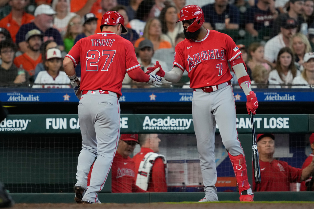 Los Angeles Angels designated hitter Mike Trout celebrates with Jo Adell (7) after scoring during the third inning of a baseball game against the Houston Astros in Houston, Sunday, March 29, 2026. (AP Photo/Ashley Landis)
