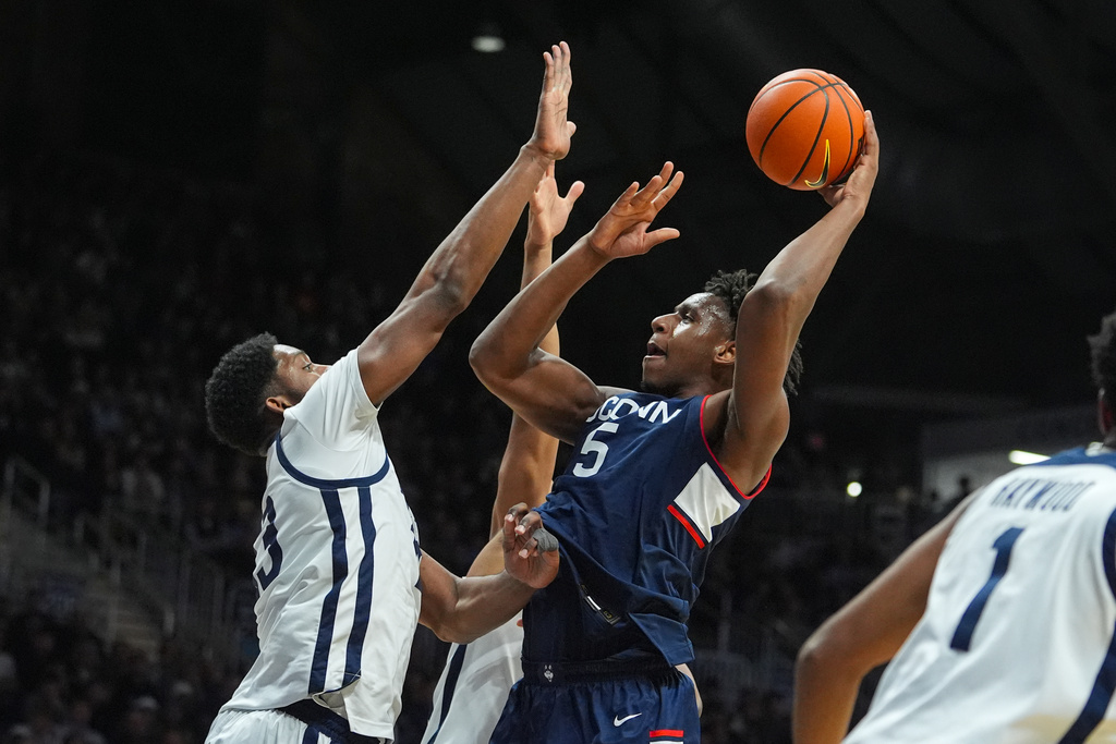 UConn forward Tarris Reed Jr. (5) shoots over Butler center Drayton Jones (13) in the first half of an NCAA college basketball game in Indianapolis, Wednesday, Feb. 11, 2026. (AP Photo/Michael Conroy)