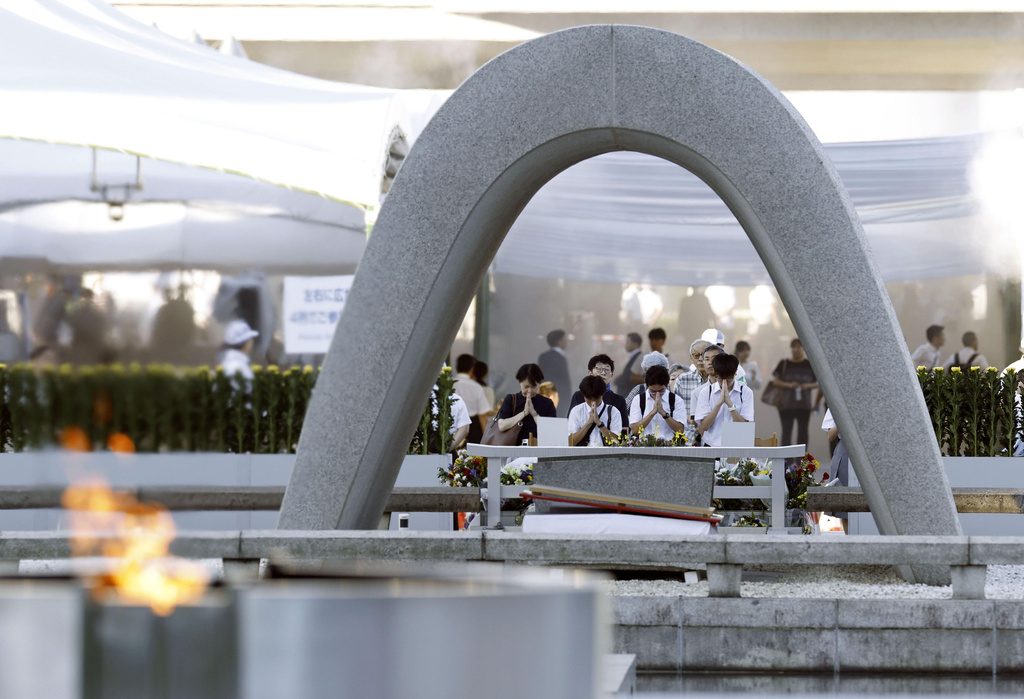 Visitors pray in front of the cenotaph dedicated to the victims of the atomic bombing ahead of a ceremony to mark the anniversary of the bombing at the Hiroshima Peace Memorial Park in Hiroshima, western Japan Thursday, Aug. 6, 2026. (Mizuki Sakai/Kyodo News via AP)