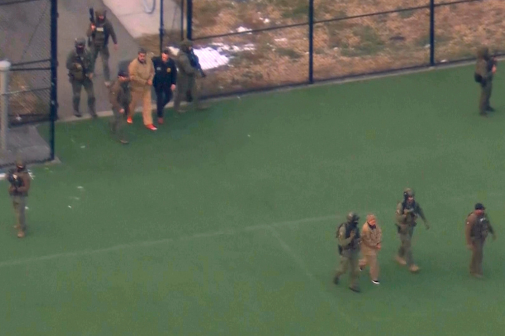 This image taken from video shows Venezuelan President Nicolas Maduro, top left, and his wife Cilia Flores, bottom right, being escorted to board a helicopter for transport to Manhattan Federal Court, Monday, Jan. 5, 2026, in New York. (WABC via AP)