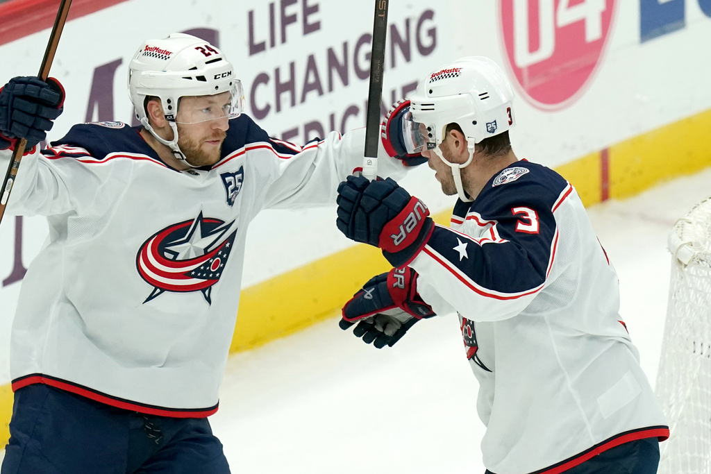 Columbus Blue Jackets' Charlie Coyle (3) celebrates with Mathieu Olivier (24) after scoring during the first period of an NHL hockey game, Saturday, Oct. 25, 2025, in Pittsburgh. (AP Photo/Matt Freed)