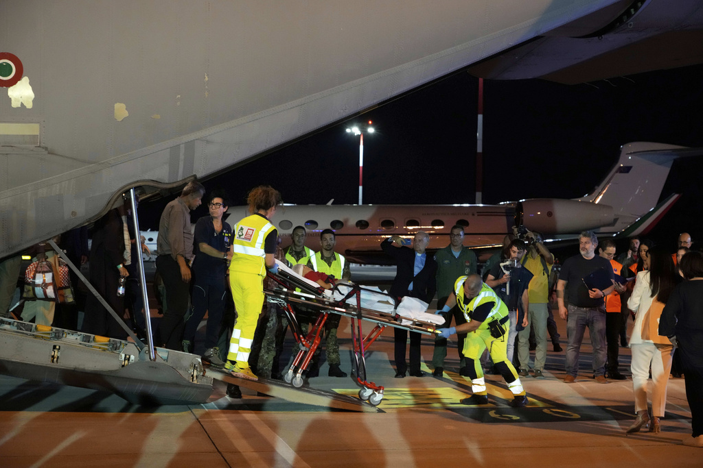 Palestinian children and their families evacuated from Gaza arrive at Rome's Ciampino military airport, Thursday, Aug. 14, 2025. (AP Photo/Gregorio Borgia)
