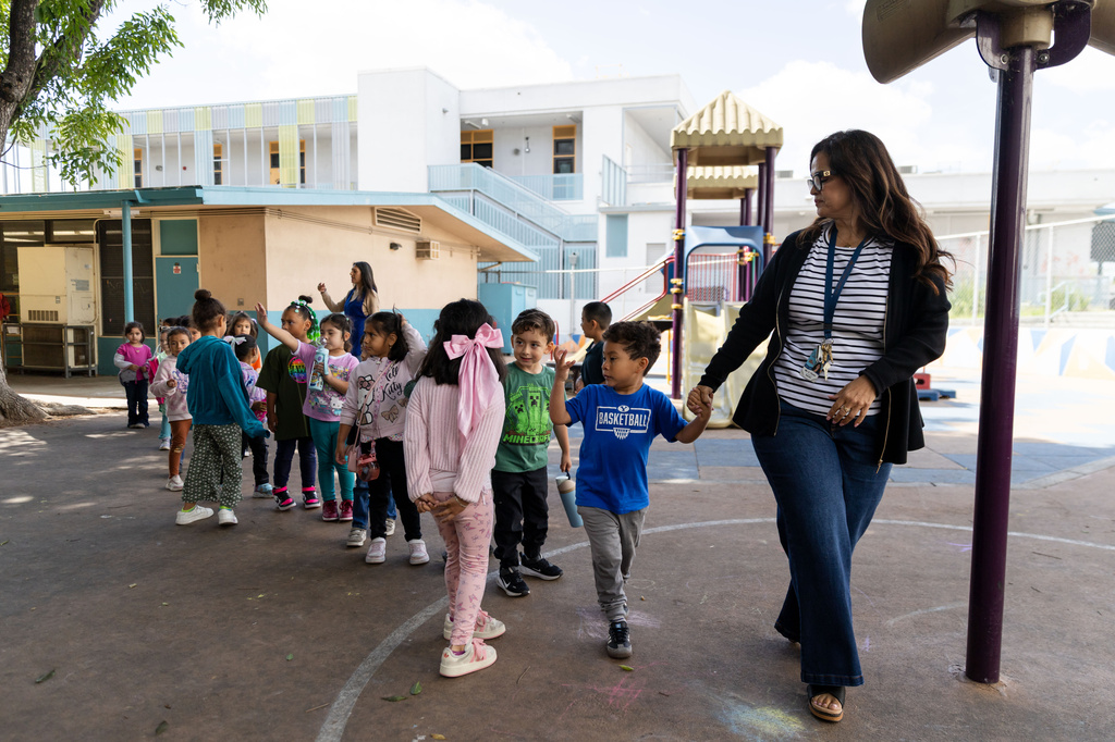 TK teacher Miss Flores leads students to lunch during a TK class at First Street Elementary School in Los Angeles, on Wednesday, April 22, 2026. (AP Photo/Ethan Swope)