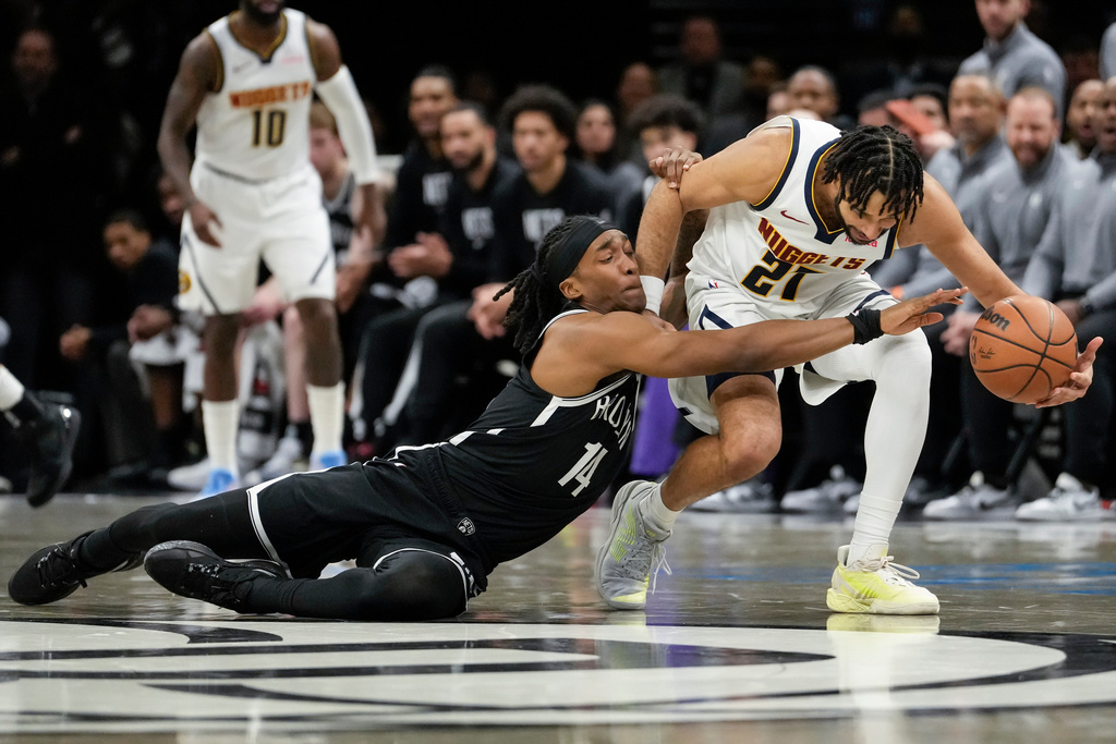 Brooklyn Nets guard Terance Mann (14) fights for control of the ball with Denver Nuggets guard Jamal Murray (27) during the first half of an NBA basketball game, Sunday, Jan. 4, 2026, in New York. (AP Photo/Yuki Iwamura)