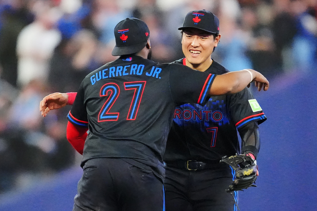 Toronto Blue Jays' Vladimir Guerrero Jr. (27) and Kazuma Okamoto (7) celebrate after defeating the Los Angeles Angels in a baseball game in Toronto, Friday, May 8, 2026. (Frank Gunn/The Canadian Press via AP)