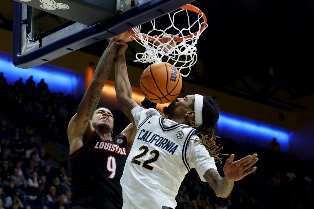 Louisville forward Khani Rooths (9) dunks the ball against California forward Chris Bell (22) during the second half of an NCAA college basketball game in Berkeley, Calif., Tuesday, Dec. 30, 2025. (AP Photo/Jed Jacobsohn)