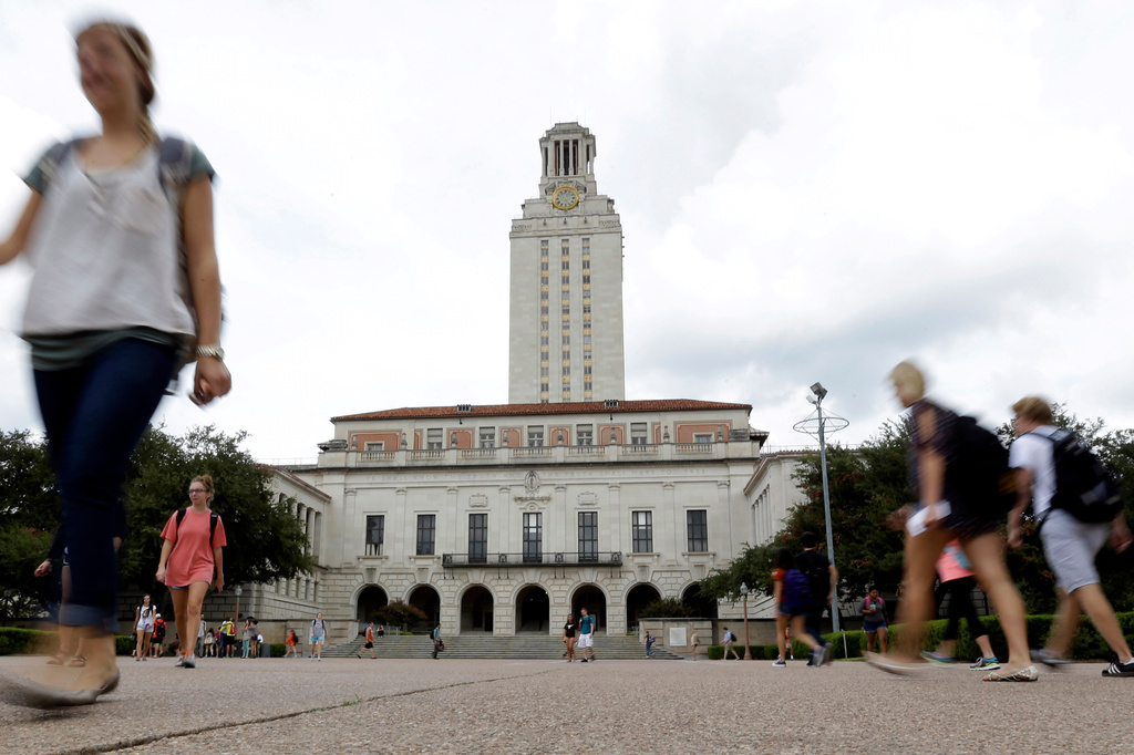 FILE - Students walk through the University of Texas at Austin campus near the school's iconic tower, Sept. 27, 2012, in Austin, Texas. (AP Photo/Eric Gay, File)