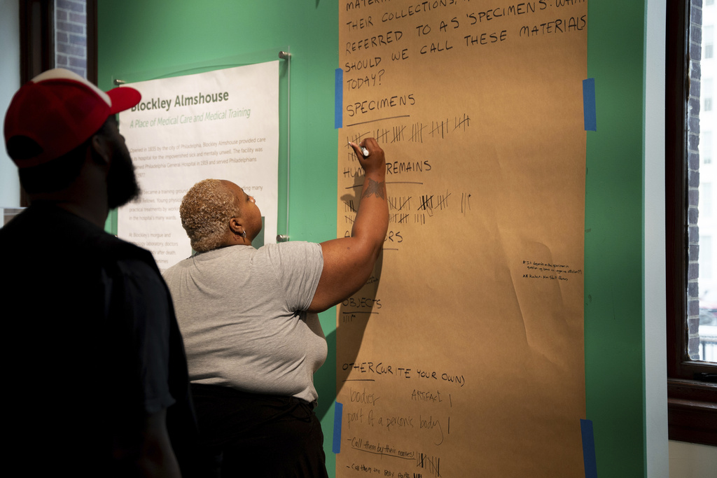 Markys Battle, 32, and Ashley Halton, 31, vote in a community feedback survey on the language surrounding items of human origin at the Mütter Museum on Thursday, Aug. 21, 2025, in Philadelphia. (AP Photo/Mingson Lau)
