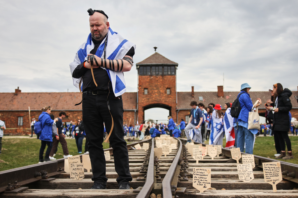 People take part in the annual "March of the Living" to commemorate the Holocaust, a yearly Holocaust remembrance march between the former death camps of Auschwitz and Birkenau, in Oswiecim, Poland, on Tuesday, April 14, 2026. (AP Photo/Beata Zawrzel)