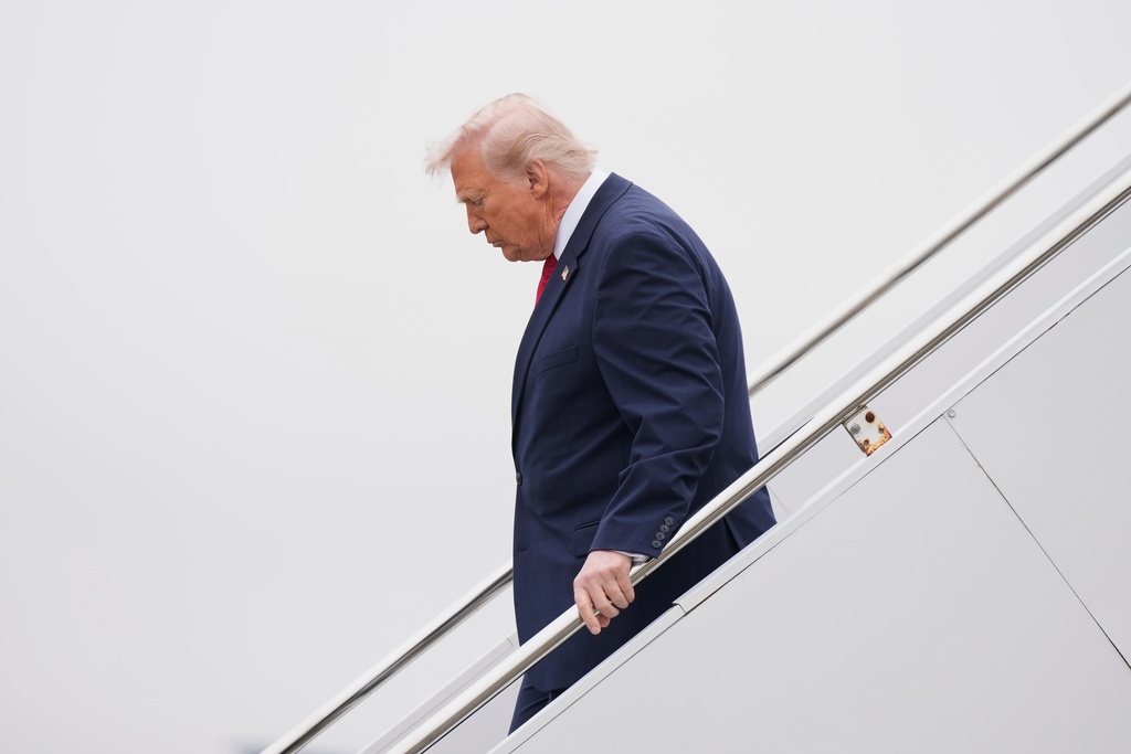 President Donald Trump steps off Air Force One, Saturday, March 7, 2026, at Dover Air Force Base, Del. (AP Photo/Mark Schiefelbein)