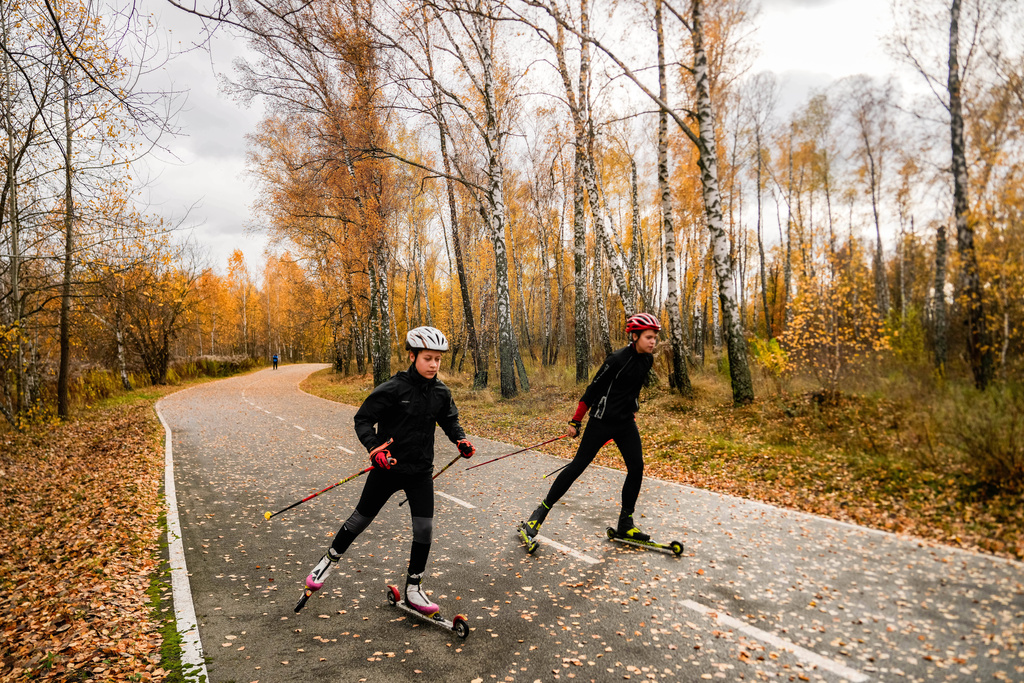 Biathletes Mykola Dorofeiev, 16, and Nazar Kravchenko, 12, left, train at the ski base in Chernihiv, Ukraine, Thursday, Oct. 30, 2025. (AP Photo/Julia Demaree Nikhinson)