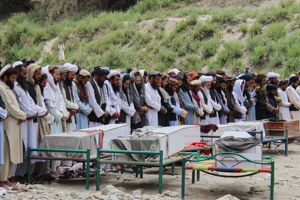 Mourners pray during a funeral for victims, including children, of airstrikes that Taliban officials said were carried out by Pakistan, in Mana, a village in Afghanistan's Khost province, Wednesday, June 10, 2026. (AP Photo/Saifullah Zahir)