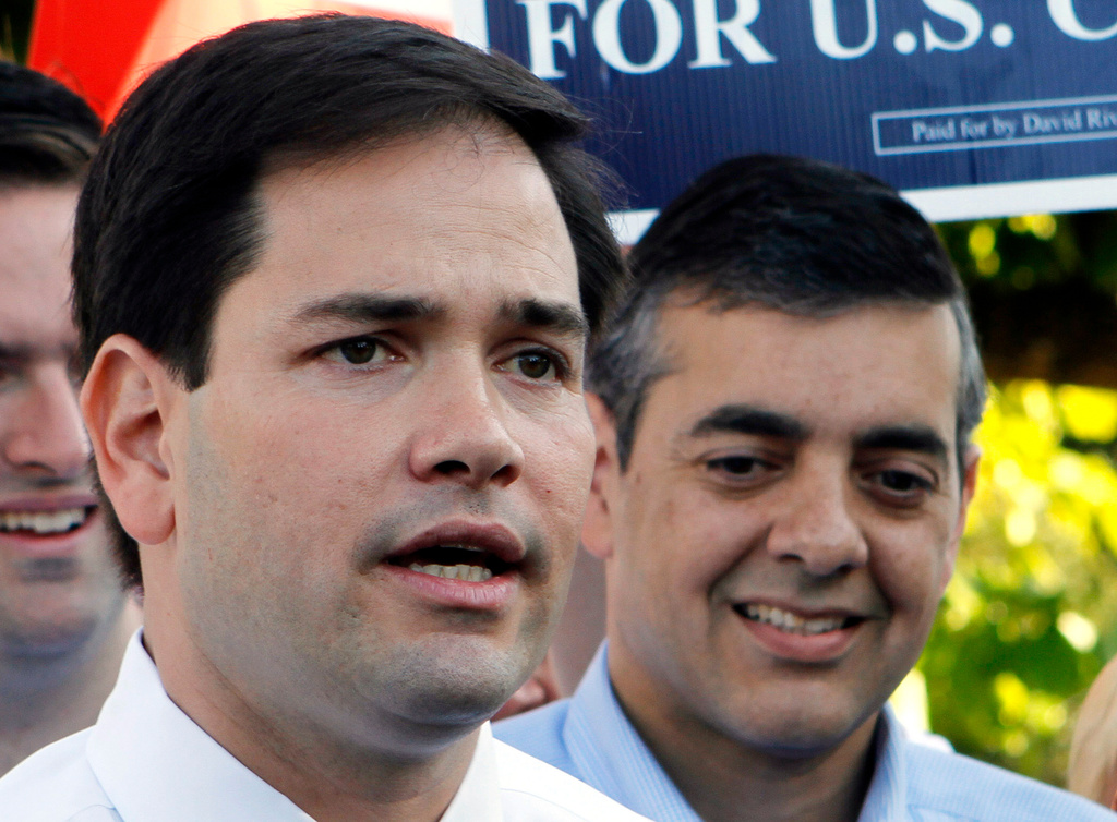 FILE - Then Republican U.S. Senate candidate Marco Rubio, left, accompanied by then Republican candidate for Congress David Rivera, talks to reporters in Miami, Oct. 20, 2010. (AP Photo/Alan Diaz, File)