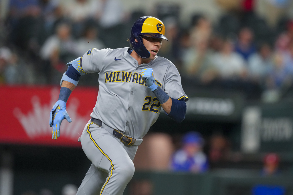 Milwaukee Brewers designated hitter Christian Yelich runs while hitting a double against the Texas Rangers during the seventh inning of a baseball game Tuesday, Sept. 9, 2025, in Arlington, Texas. (AP Photo/Julio Cortez)