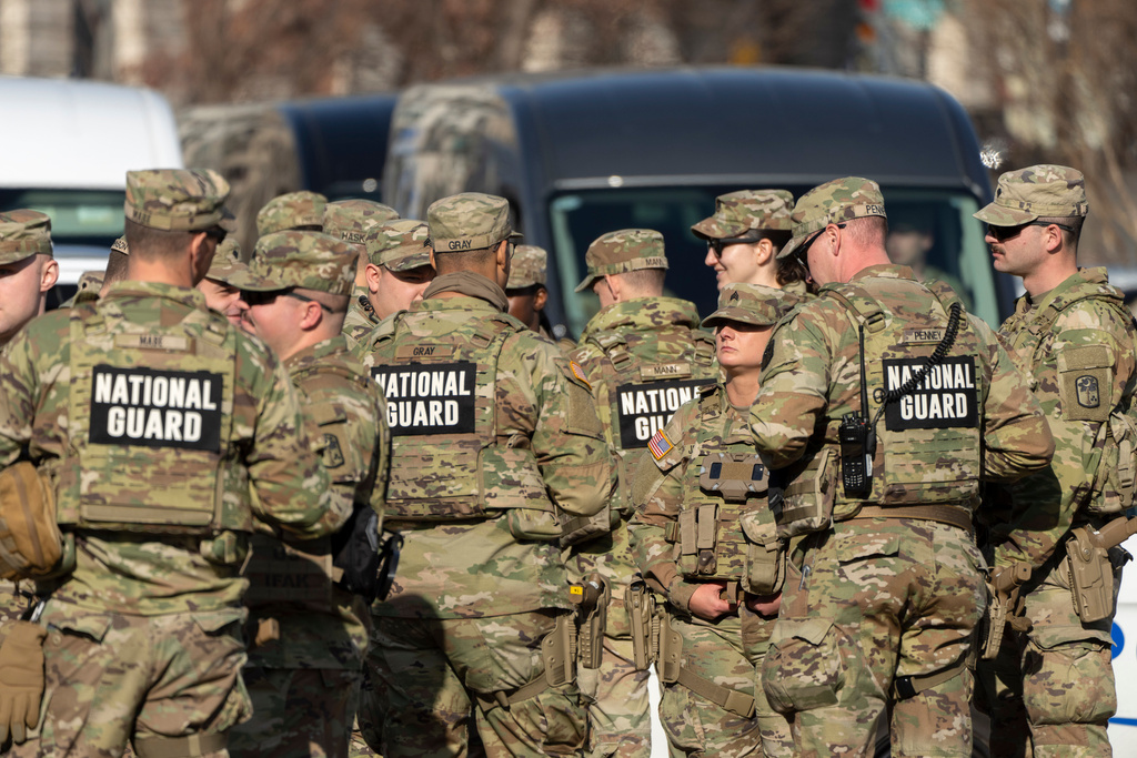 National Guard members gather before the body of Metropolitan Police Department officer Terry Bennett is driven past the Capitol, Thursday, Jan. 8, 2026, in Washington. (AP Photo/Mark Schiefelbein)
