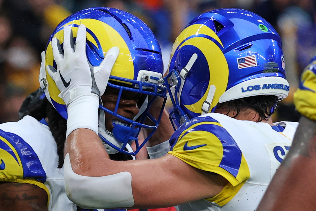 Los Angeles Rams wide receiver Davante Adams (17), left, celebrates with Los Angeles Rams quarterback Matthew Stafford (9) after scoring a touchdown during the first half of an NFL football game between the Los Angeles Rams and the Jacksonville Jaguars in London, Sunday, Oct. 19, 2025. (AP Photo/Ian Walton)