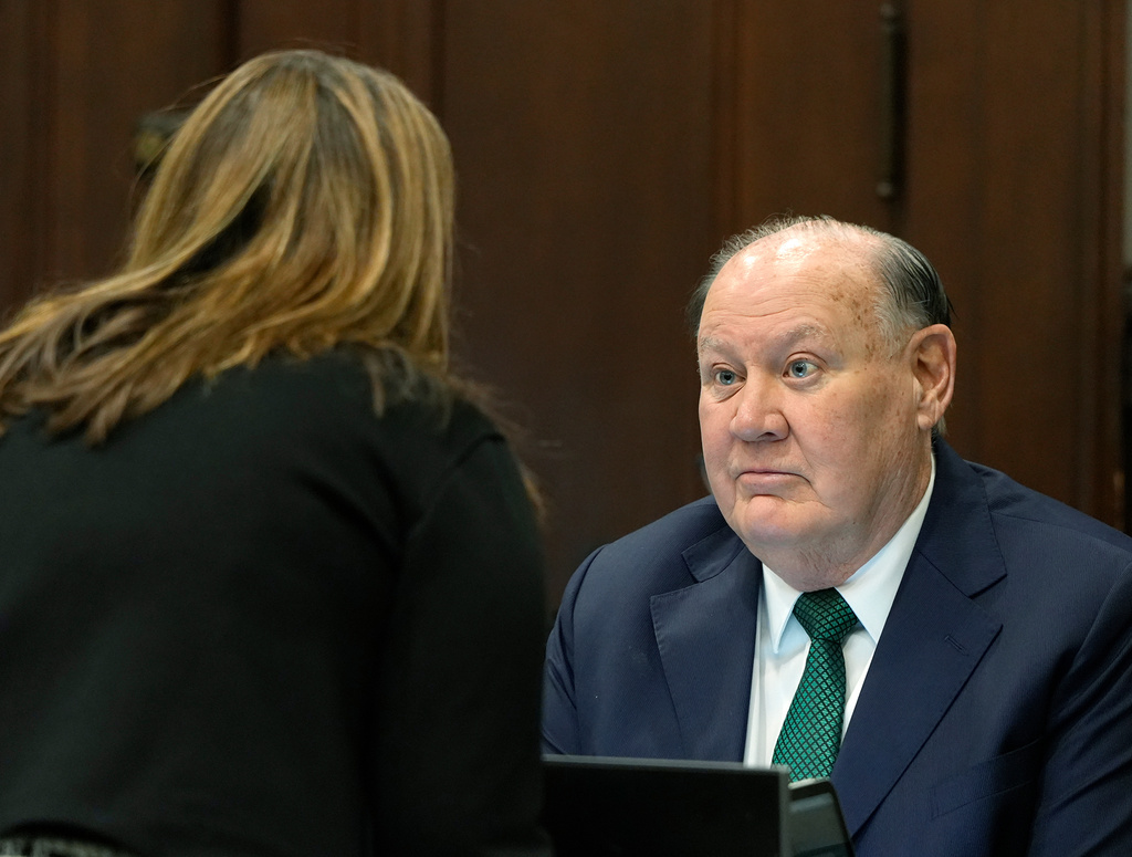 Defense attorney Rachael Israel talks chats with former FirstEnergy CEO Chuck Jones before the start of closing arguments in his trial in Summit County Common Pleas Judge Susan Baker Ross's courtroom in Akron on Tuesday, March 17, 2026. (Mike Cardew/Akron Beacon Journal via AP, Pool)