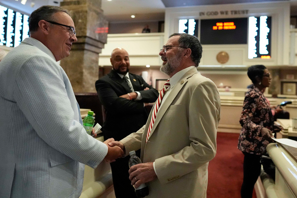 Republican state Rep. Chris Pringle, center, speaks to a colleague on the House floor during a special session of the Alabama Legislature, Tuesday, May 5, 2026, in Montgomery, Ala. (AP Photo/Mike Stewart)