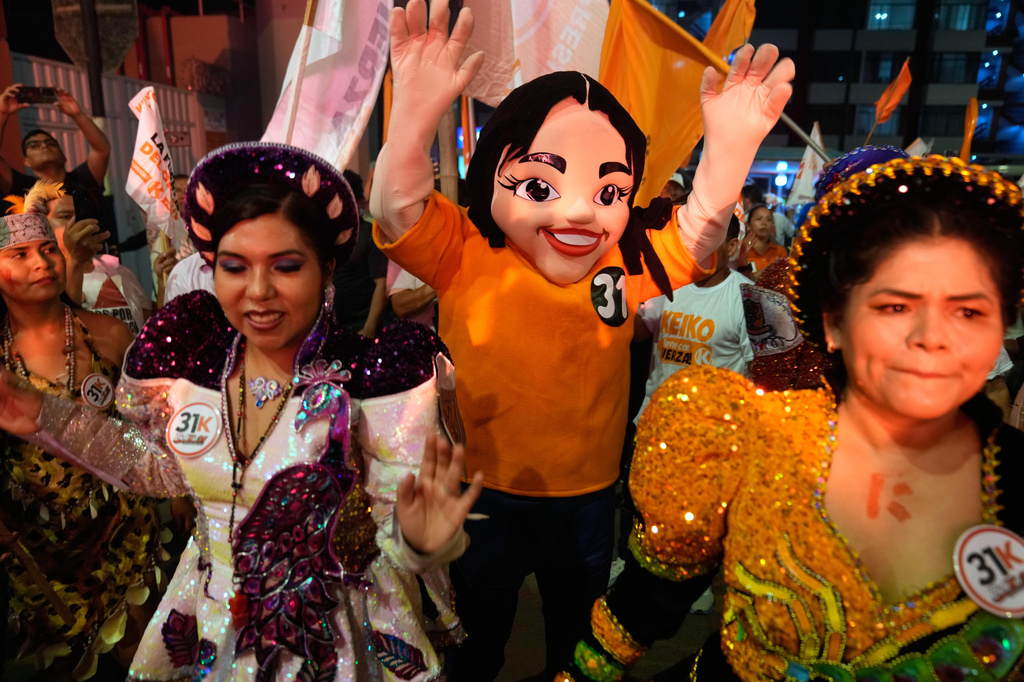 Supporters of presidential candidate Keiko Fujimori, of the Popular Force party, cheer outside of a debate ahead of the April 12 election in Lima, Peru, Tuesday, March 31, 2026. (AP Photo/Martin Mejia)