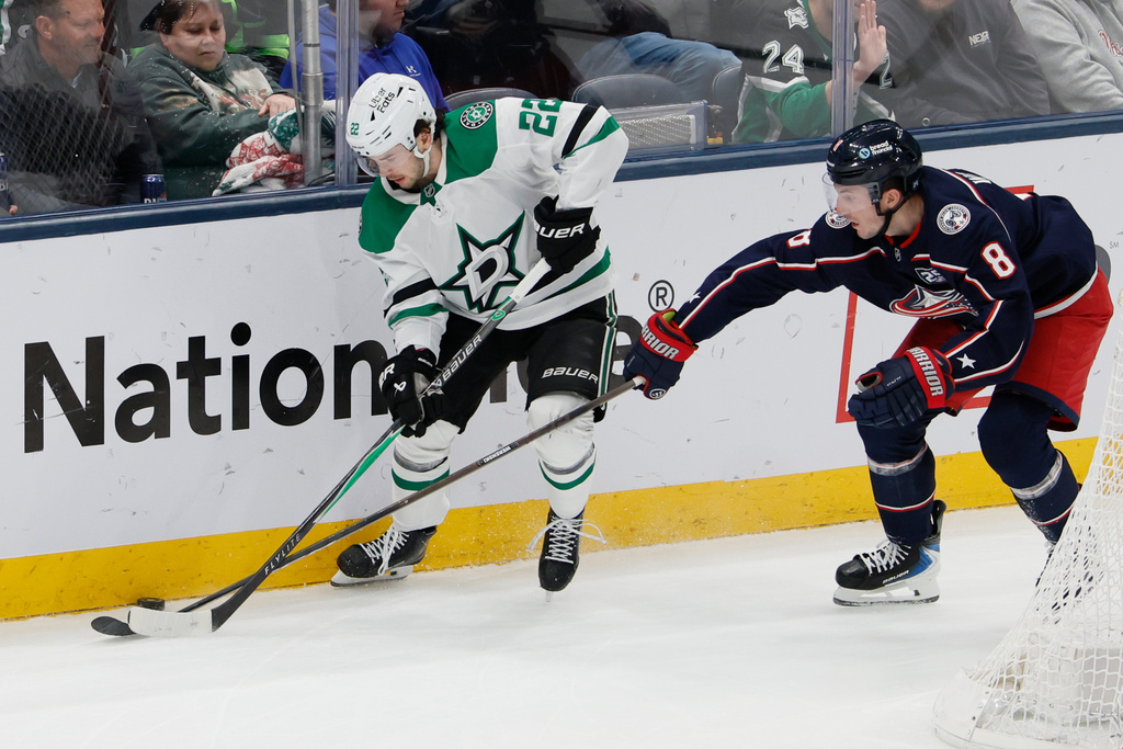 Dallas Stars' Mavrik Bourque, left, controls the puck as Columbus Blue Jackets' Zach Werenski defends during the third period of an NHL hockey game, Thursday, Jan. 22, 2026, in Columbus, Ohio. (AP Photo/Jay LaPrete)