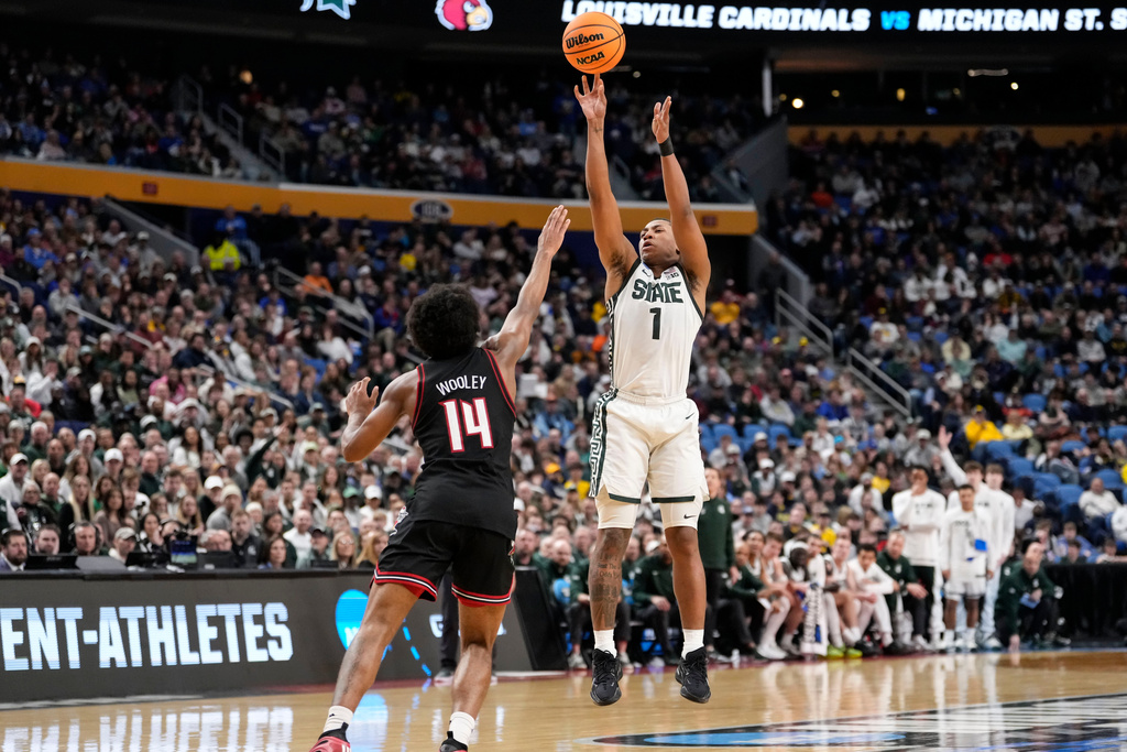 Michigan State guard Jeremy Fears Jr. (1) shoots a 3-pointer over Louisville during the first half in the second round of the NCAA college basketball tournament, Saturday, March 21, 2026, in Buffalo, N.Y. (AP Photo/Yuki Iwamura)