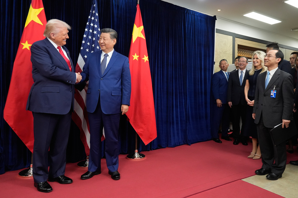 President Donald Trump, left, and Chinese President Xi Jinping, second left, shake hands before their meeting at Gimhae International Airport in Busan, South Korea, Thursday, Oct. 30, 2025. (AP Photo/Mark Schiefelbein)