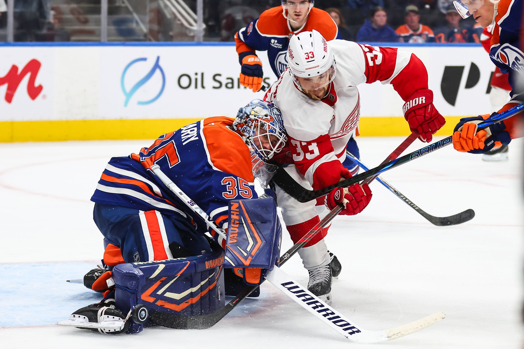 Edmonton Oilers goaltender Tristan Jarry (35) battles against Detroit Red Wings' Viktor Arvidsson (33) during third period NHL hockey action in Edmonton, Alberta, Monday, Oct. 26, 2026. (Codie McLachlan/The Canadian Press via AP)