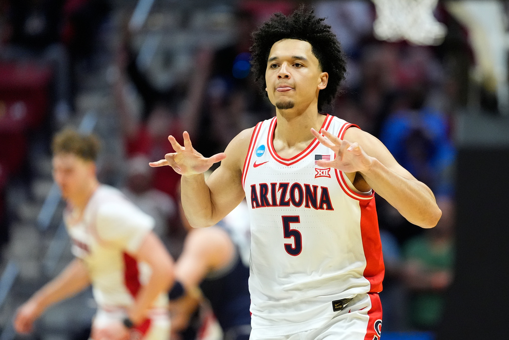 Arizona guard Brayden Burries (5) celebrates after a play against Utah State during the second half of a game in the second round of the NCAA college basketball tournament Sunday, March 22, 2026, in San Diego. (AP Photo/Mark J. Terrill)