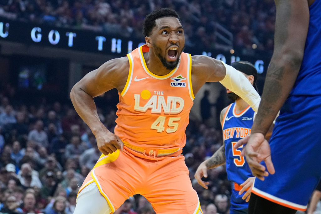 Cleveland Cavaliers guard Donovan Mitchell (45) reacts after dunking in the first half of an NBA basketball game against the New York Knicks in Cleveland, Tuesday, Feb. 24, 2026. (AP Photo/Sue Ogrocki)