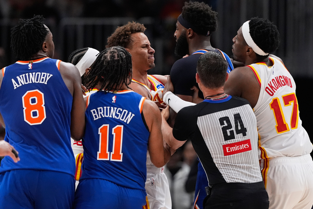 New York Knicks center Mitchell Robinson (23) and Atlanta Hawks guard Dyson Daniels (5) fight in the first half during Game 6 in a first-round NBA basketball playoffs series Thursday, April 30, 2026, in Atlanta. (AP Photo/Brynn Anderson)