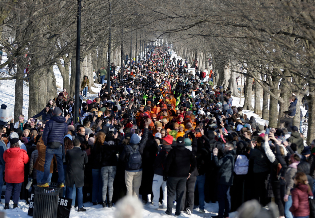 Buddhist monks walk on the National Mall near the Lincoln Memorial, during the Walk For Peace, Wednesday, Feb. 11, 2026, in Washington. (AP Photo/Rahmat Gul)