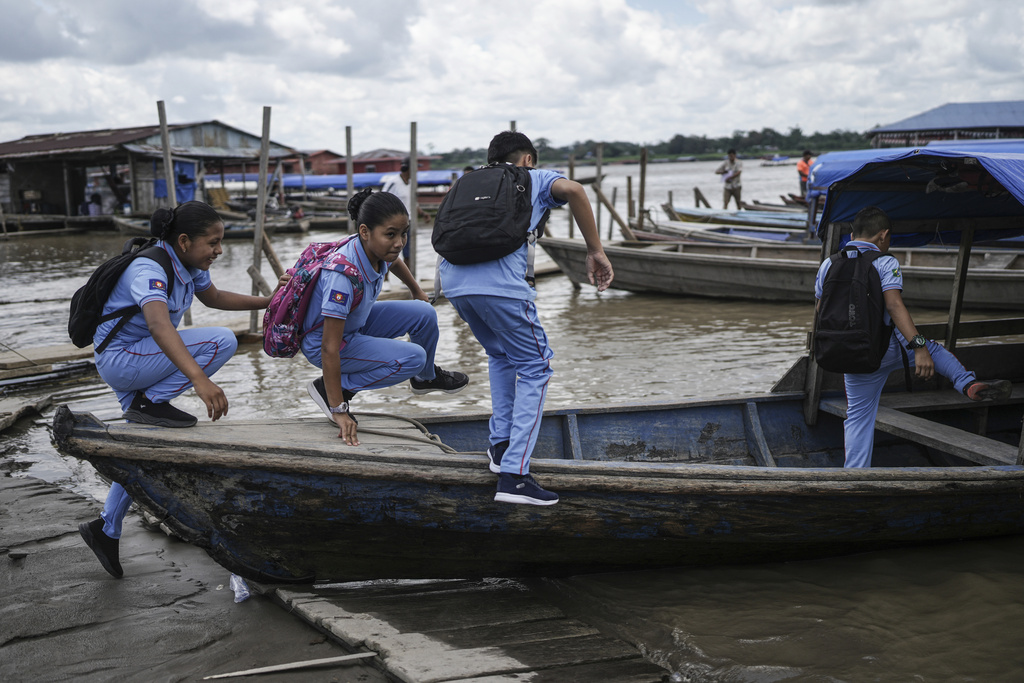 Students board a boat after attending classes in Santa Rosa, Peru, an island on the Amazon River at the triple border with Colombia and Brazil, as they head home to Tabatinga, Brazil, on a triple border with Colombia, Monday, Aug. 18, 2025. (AP Photo/Ivan Valencia)